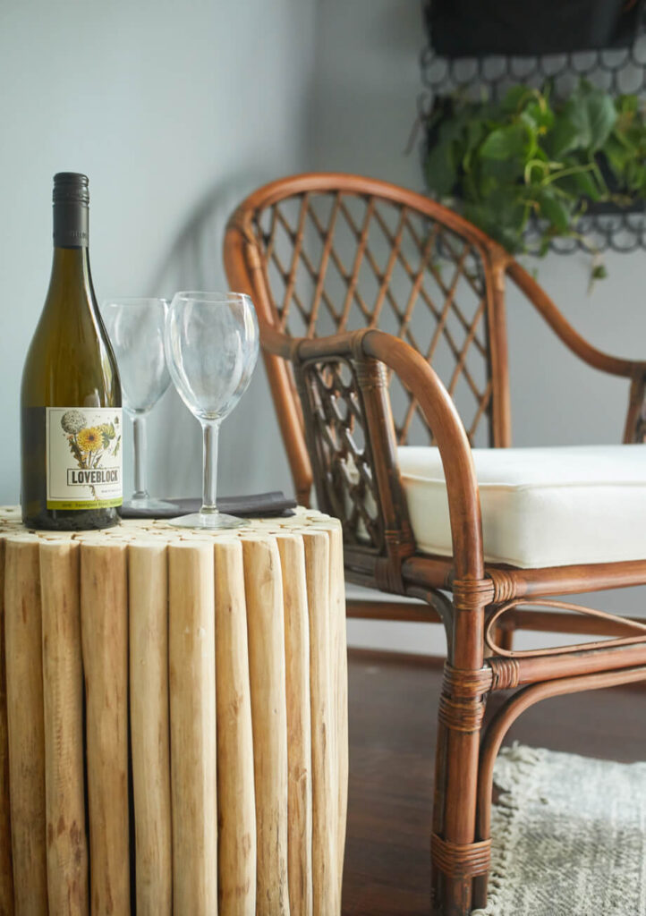 Bottle of wine and wine glasses on a side table.