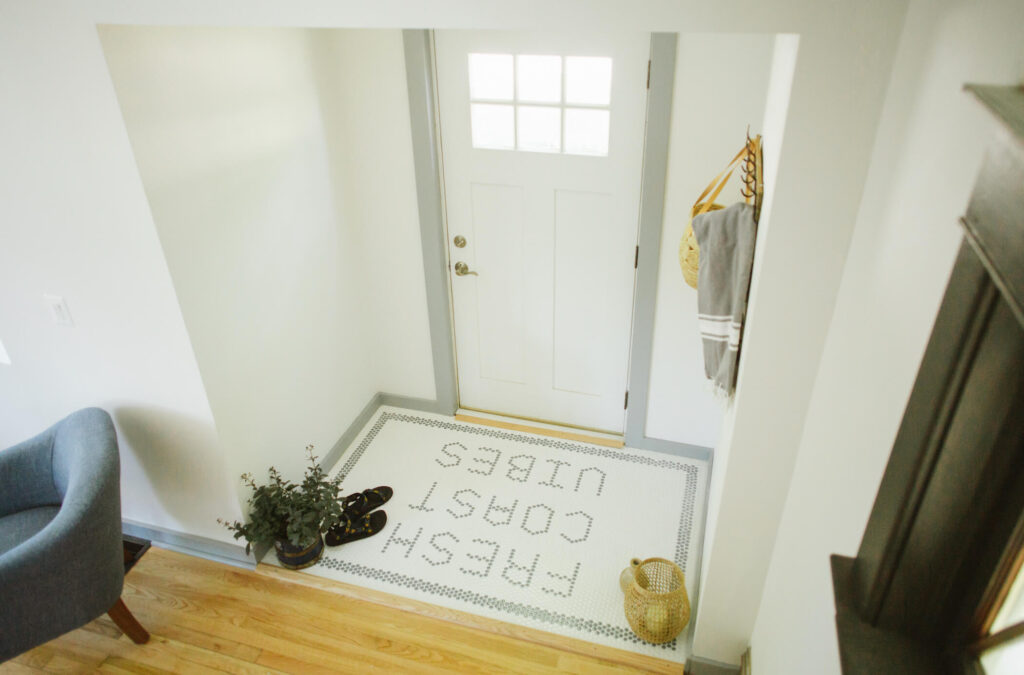 Fresh Coast Vibes is spelled out in Penny tiles in an entryway.