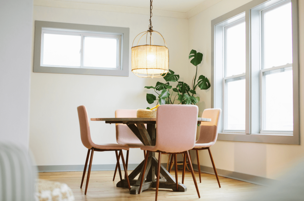 Modern Cottage Dining Area with pink chairs.