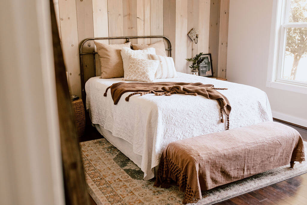 Bed showing Cozy warm bedding and textiles for Fall.