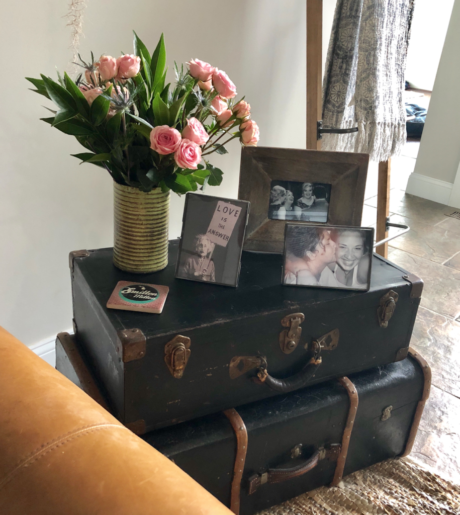 Black vintage suitcases in living room as side table.