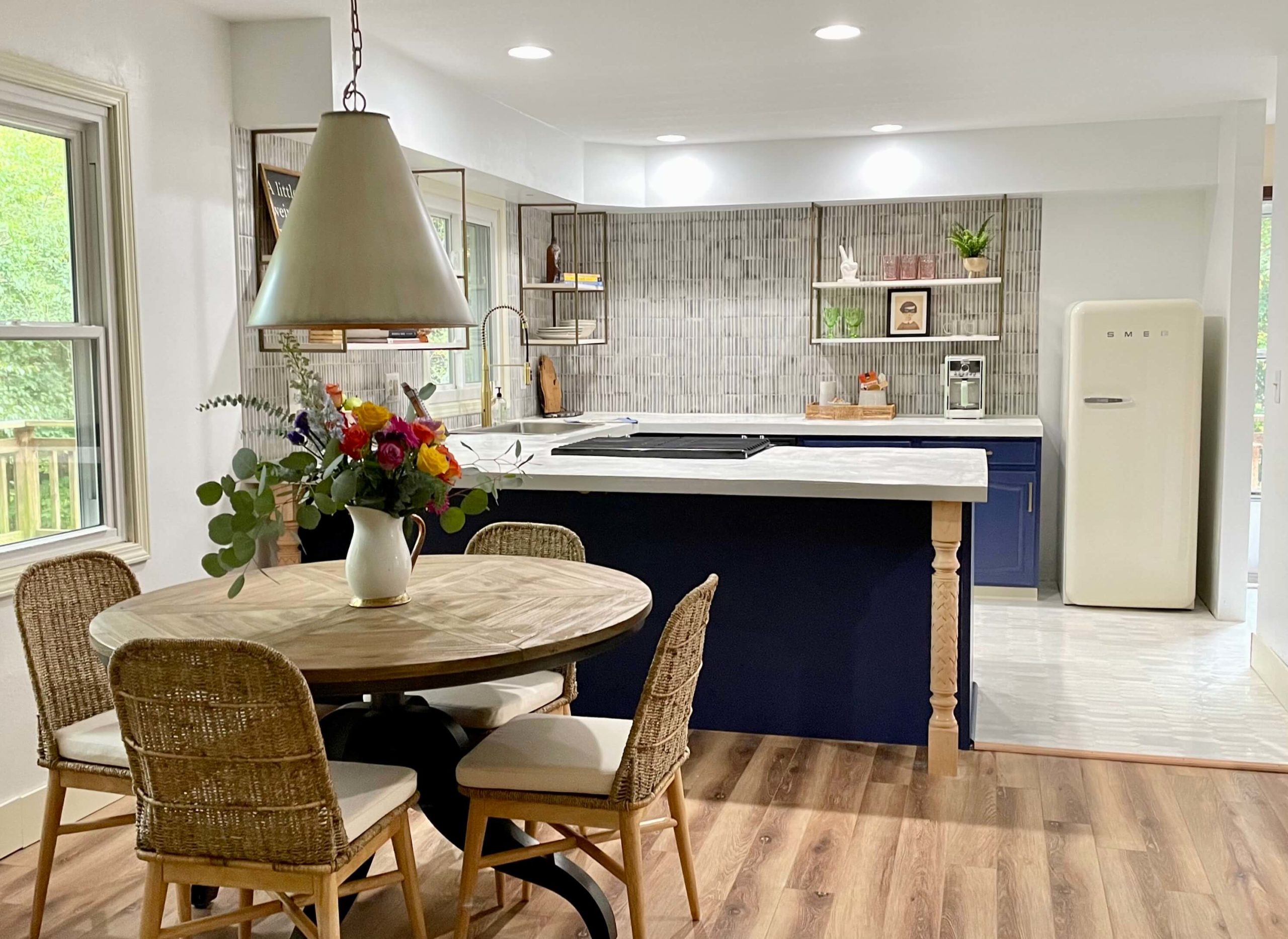Modern Cottage Kitchen with White concrete countertops and painted navy cabinets blue and white striped tile