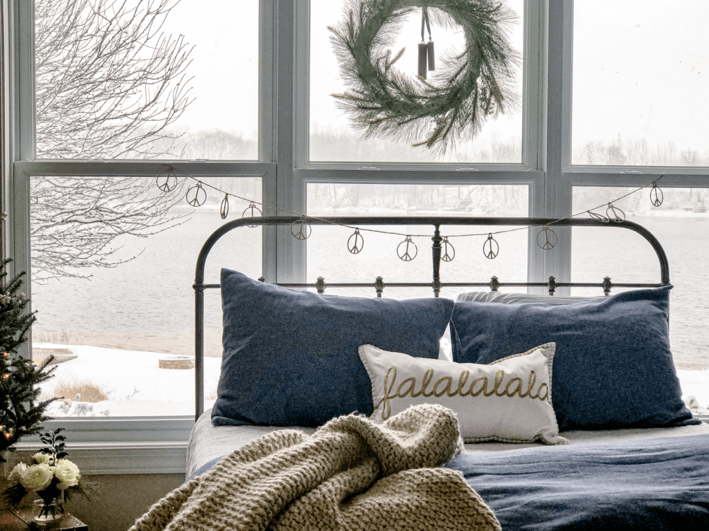 Neutral Christmas Decor with Peace Sign Garland overlooking lake.