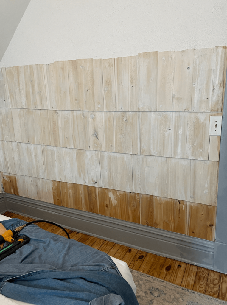 Showing the process of whitewashing accent wall