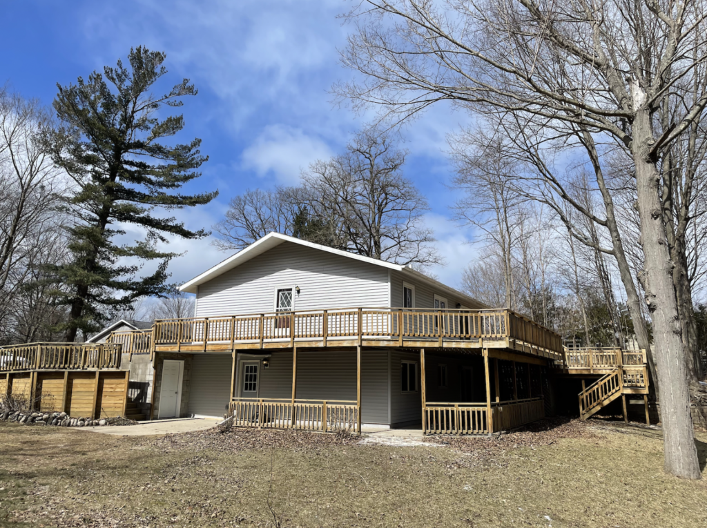 Outdoor Photo of Airbnb in Pentwater, MI. Showing two tier deck.
