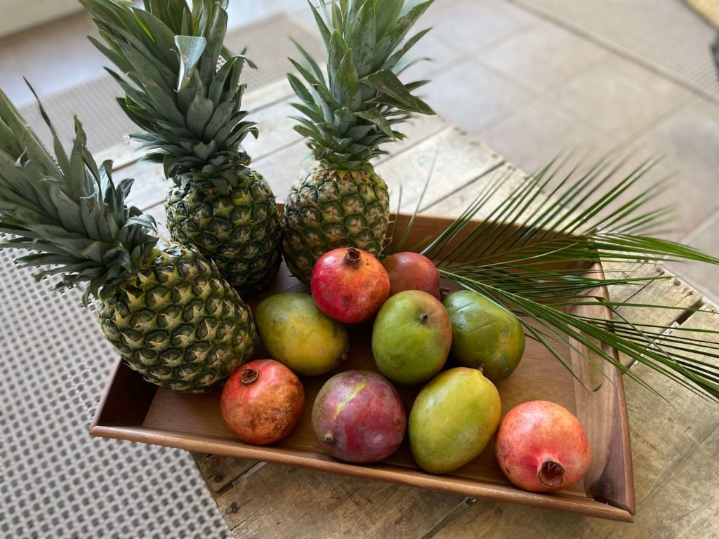 Mangos, pineapples and pomegranates for a tropical table setting.
