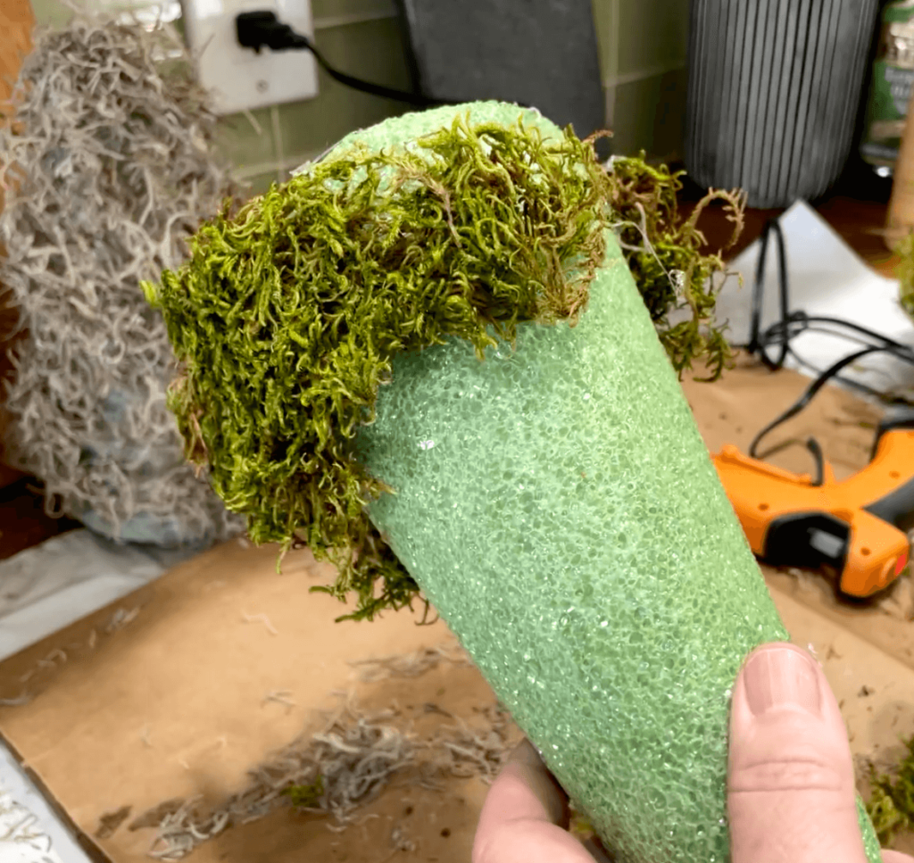 Putting Moss on Styrofoam Tree to make a DIY succulent Holiday decoration.

