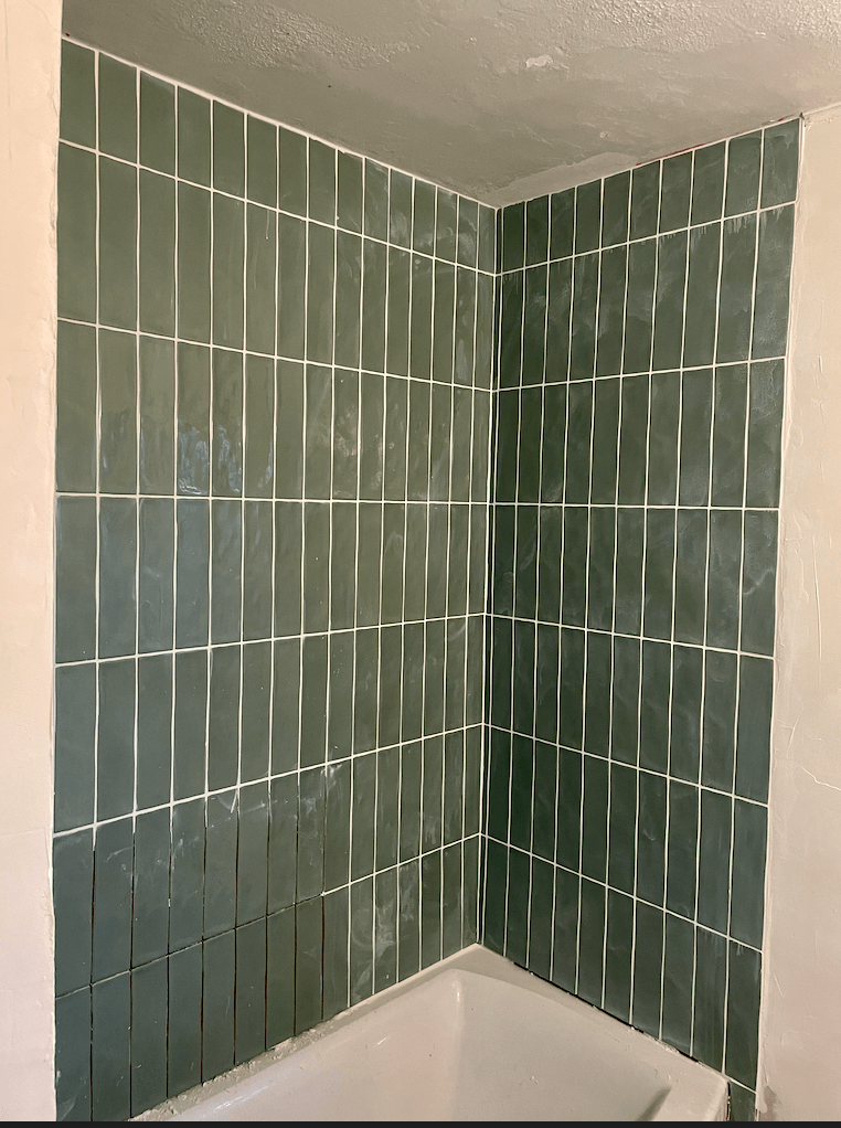 Green shower tile in a stacked pattern for a bathroom remodel.