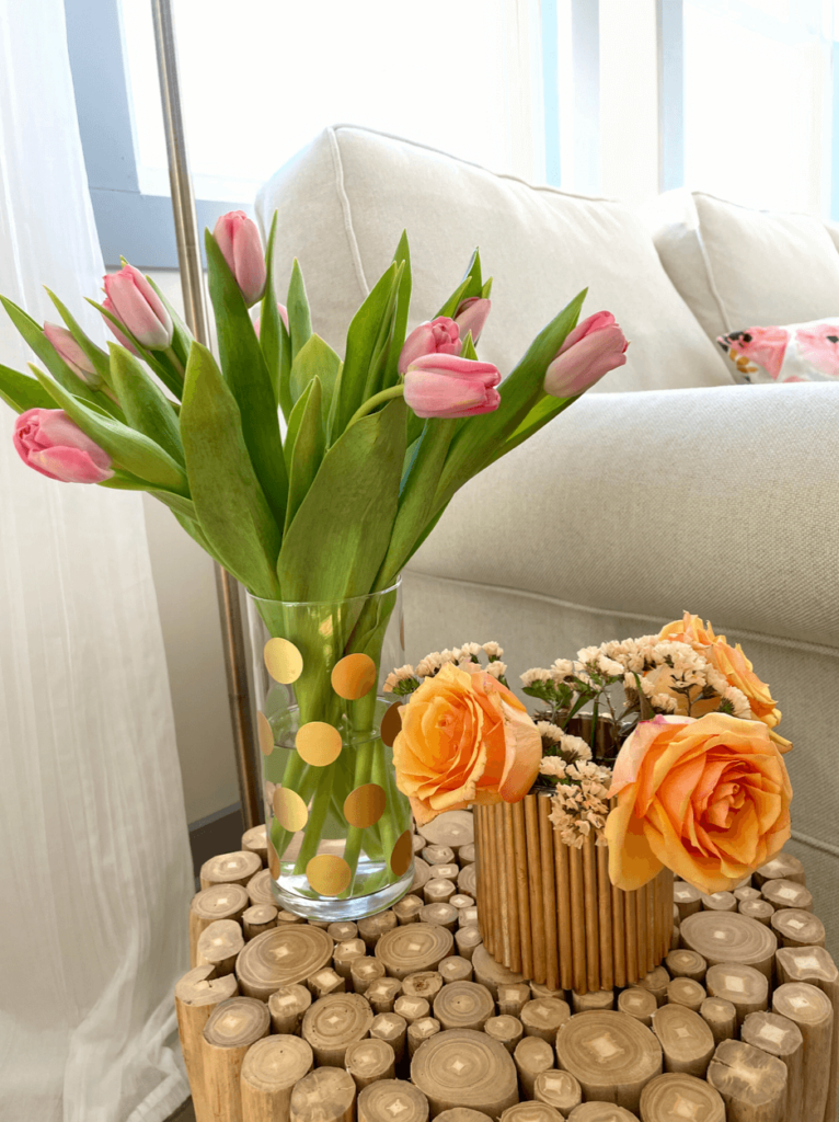 Pink tulips in a glass vase with gold polka dots.
