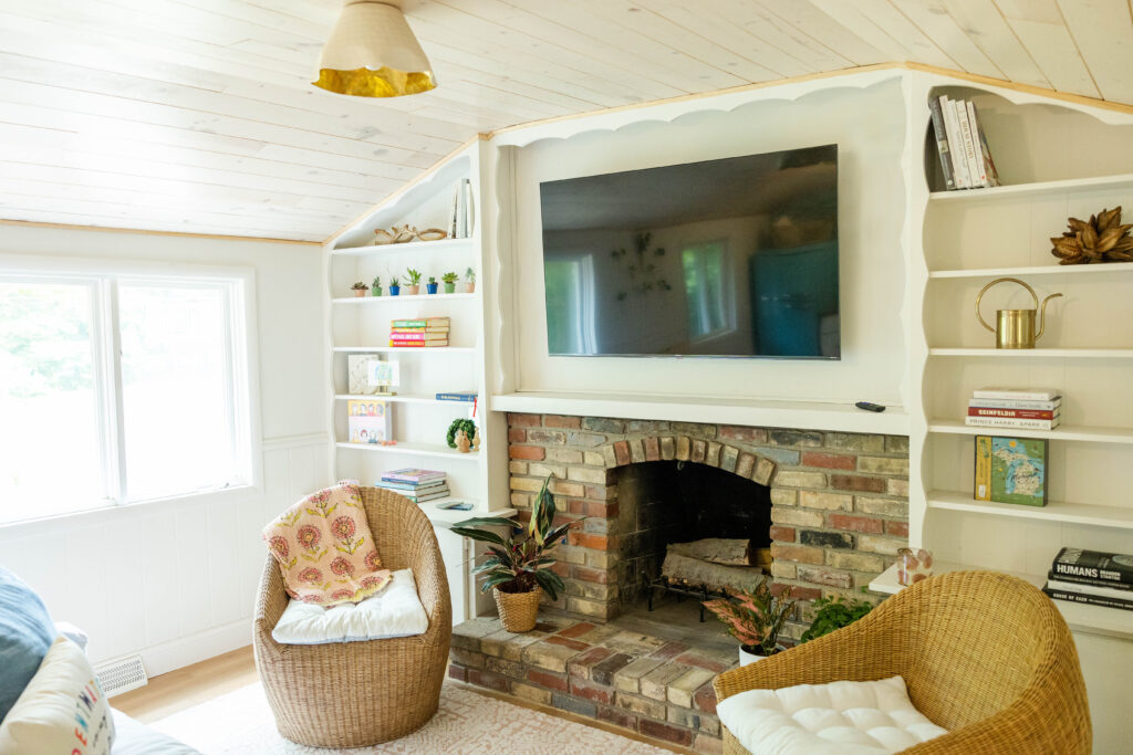 Cottage living room with fireplace and bookcases.