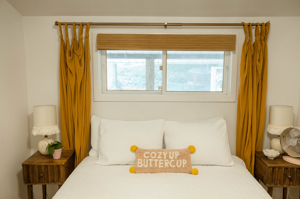 Guest Bedroom in a 650 square foot cottage showing white bedroom with gold accents.