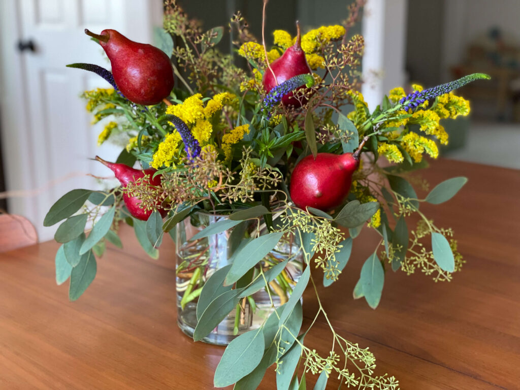 Fruit and Flowers arrangement. Red pears, eucalyptus, goldenrod combine to create a stunning fall arrangement.