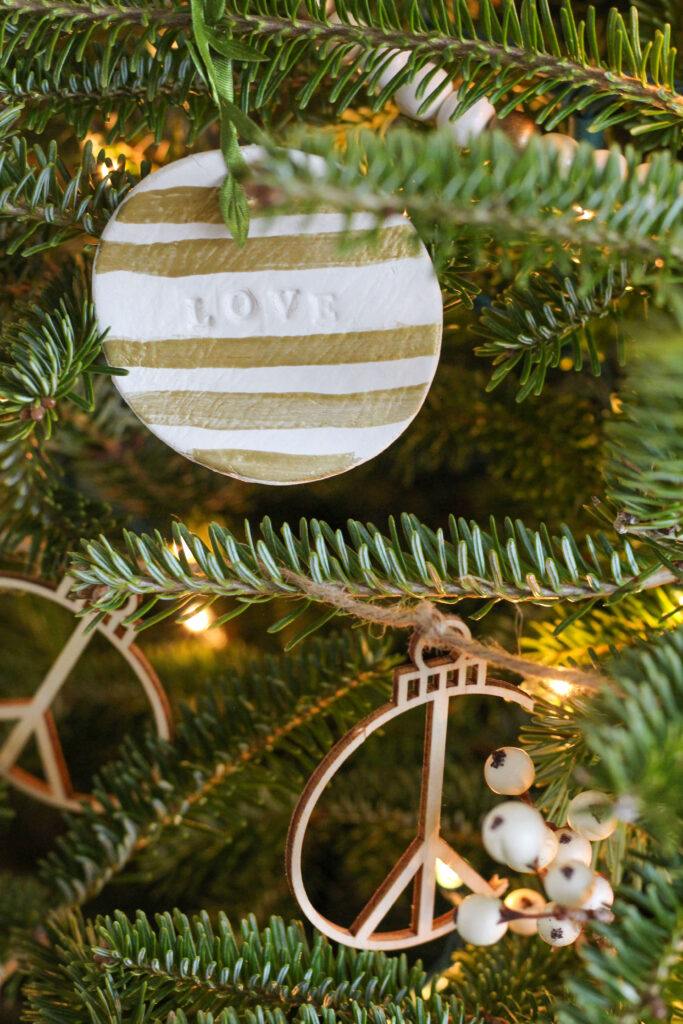 Air Dry Clay Ornament with gold stripes and the word love.