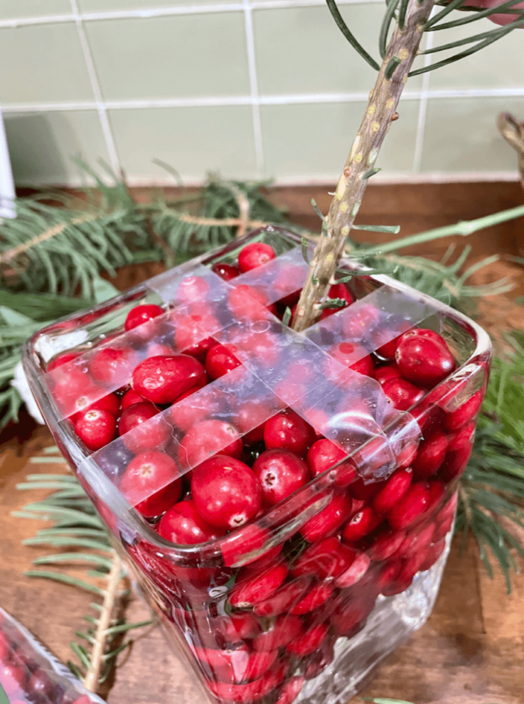Vase filled with cranberries for a DIY Holiday Centerpiece.