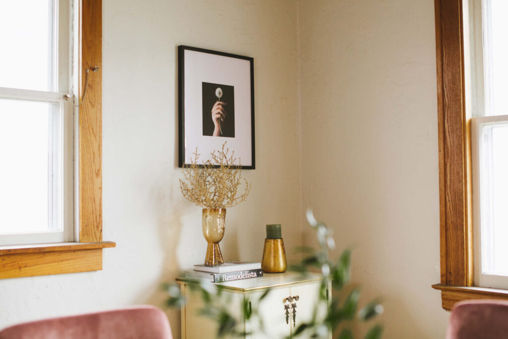 Dining room with a framed pic of a dandelion.