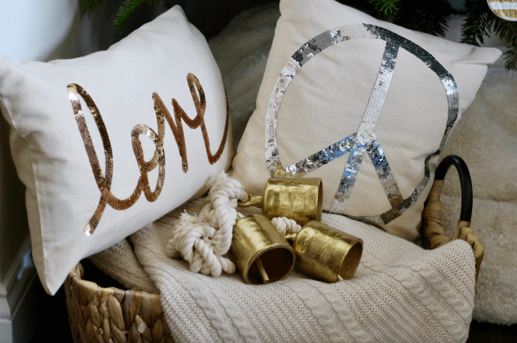 Basket full of Holiday Pillows in neutrals.