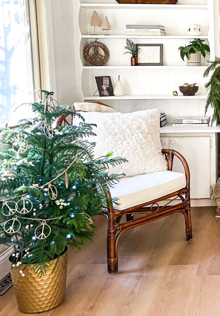 White chair with a live Norfolk Pine decorated in neutrals for the Holidays