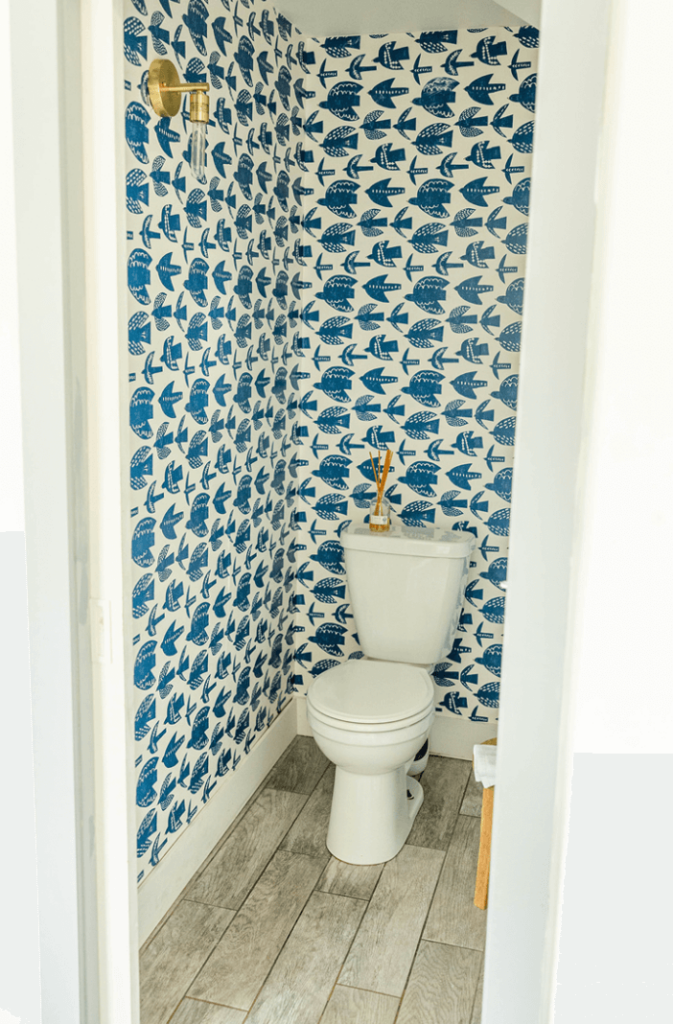 Coastal and Beachy patterned wallpaper in a powder room.