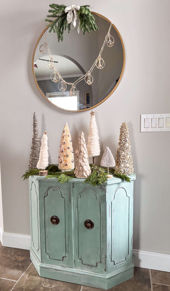 Textured mini trees in entryway for a neutral and natural home tour.