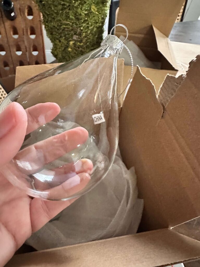 Empty glass ornament shaped like a teardrop.