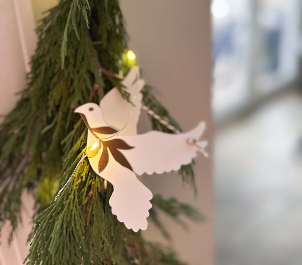 Fresh garland with paper peace doves.