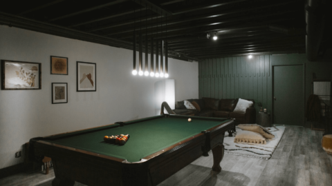 Dark and Moody Basement remodel with black painted ceilings.