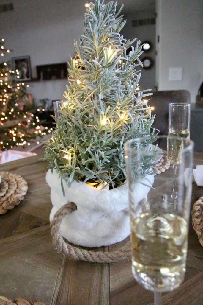 Small topiary Christmas tree in a white basket.