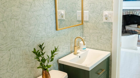 Small Cottage Bathroom with green cabinet and A-Street Prints wallpaper.