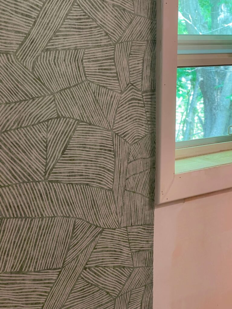 Green Wallpaper being installed in a cottage bathroom