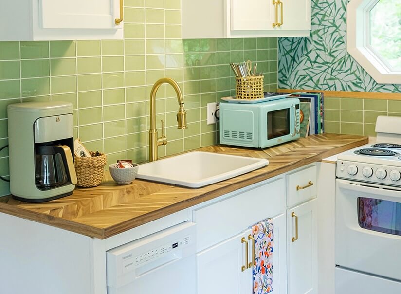 Cottage Kitchen with butcher block counters and green glass tile.