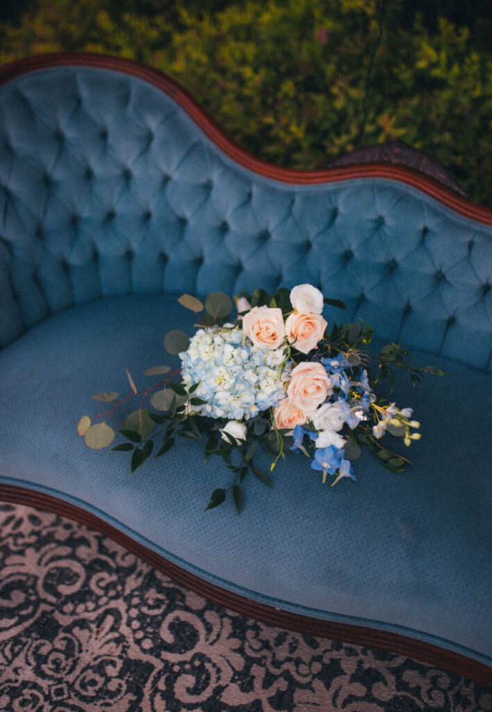 Bridal bouquet as decor on a vintage blue settee.
