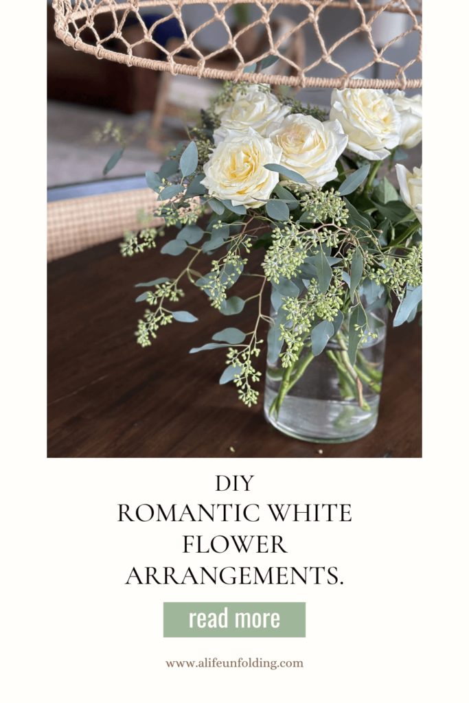 Vase of white garden roses in the middle of a dining table.