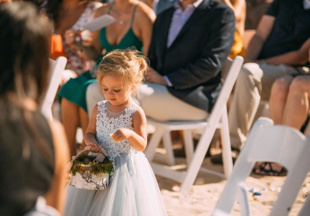 Flower Girl in blue dress at a beach wedding.