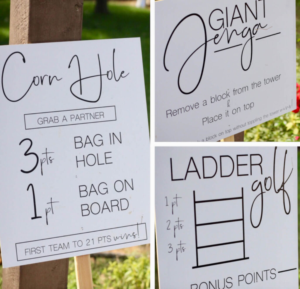 Signs for yard games at an outdoor wedding reception.