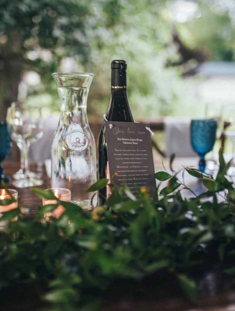 Wine bottle as table decor for an outdoor wedding decor.