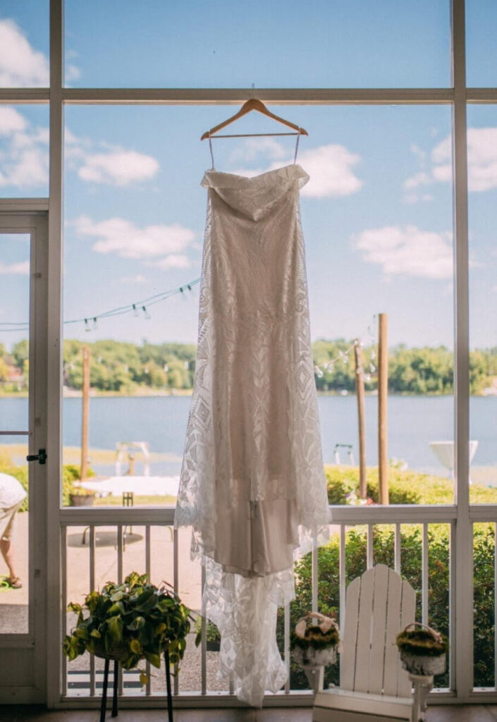 Wedding Dress hanging on a covered porch for an outdoor wedding.