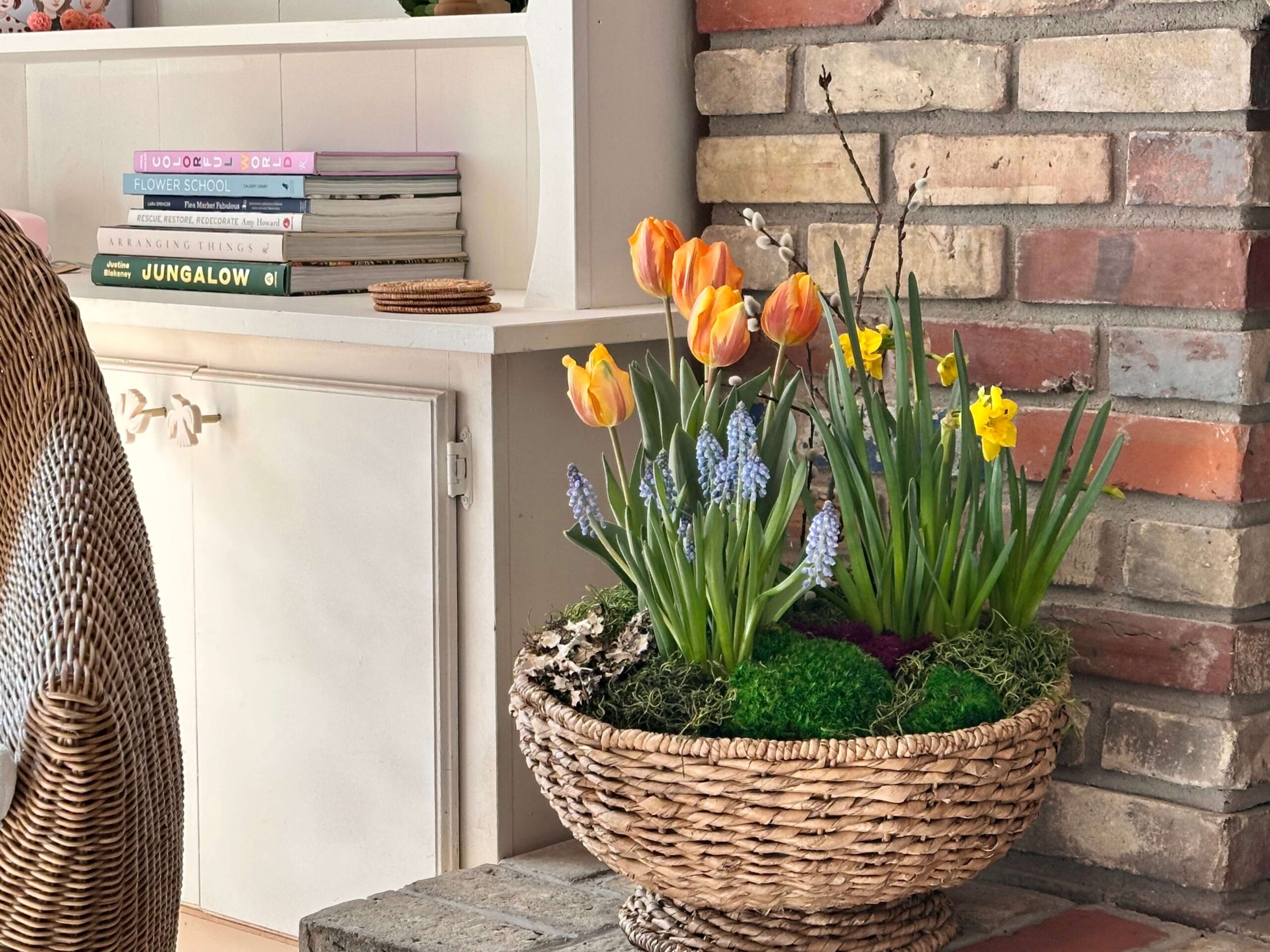 Simple Spring Bulbs in a basket in front of a fireplace.