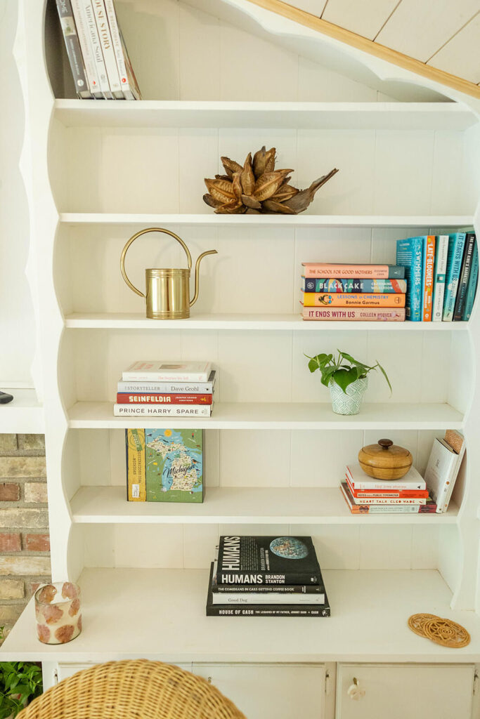 Cottage Book Shelves featuring Books, plants and more.