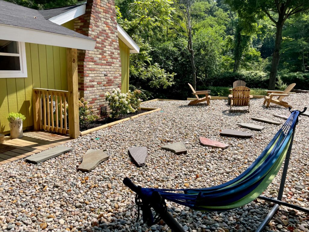 Rocks for landscaping at a green cottage with a hammock. 