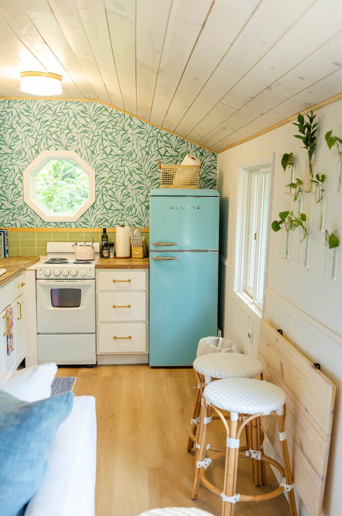 Small cottage kitchen with blue retro fridge, 