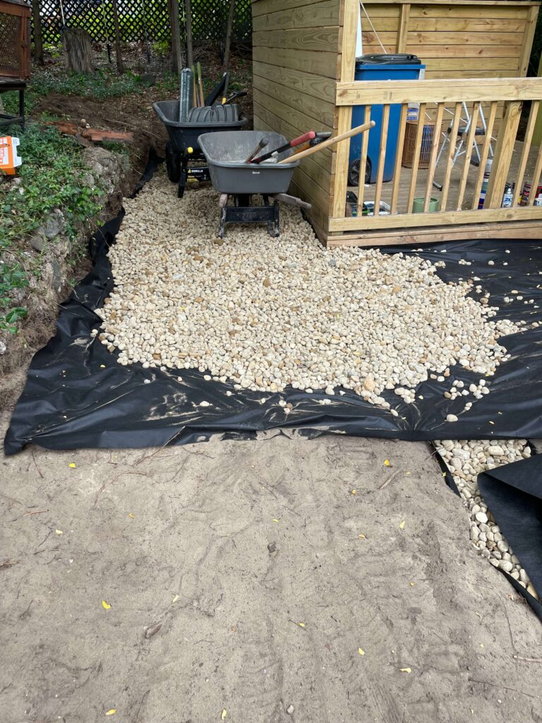 Rocks being laid in landscaping for a lake cottage.