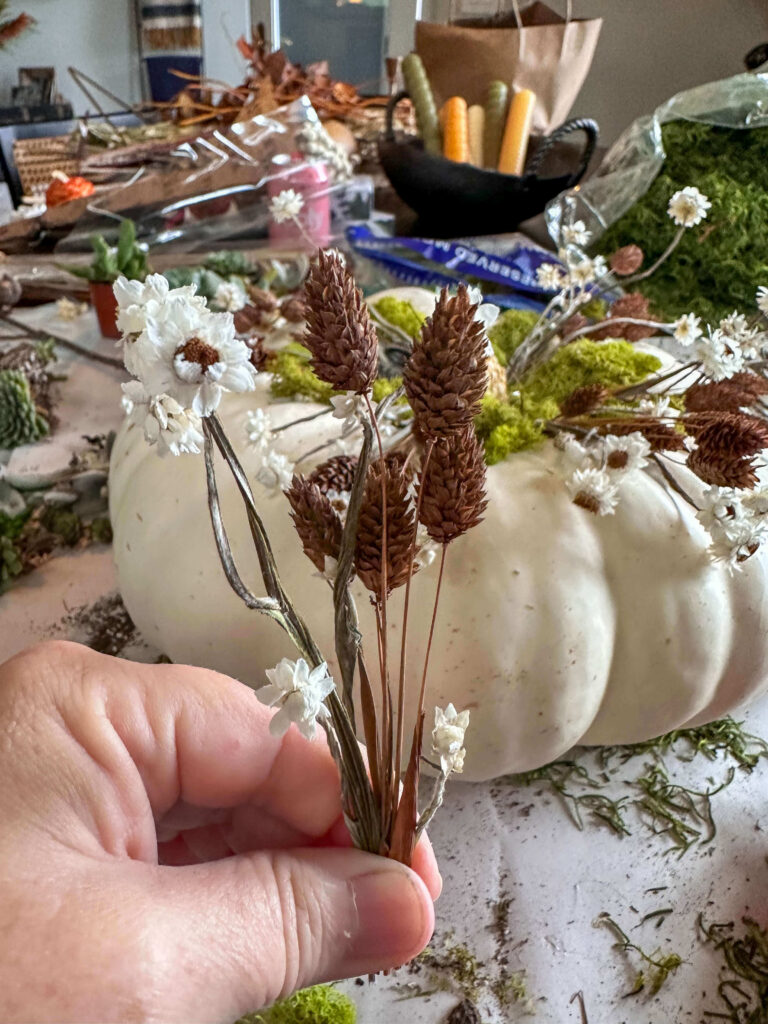 DIY Pumpkin Centerpiece with white heirloom pumpkin and dried flowers.