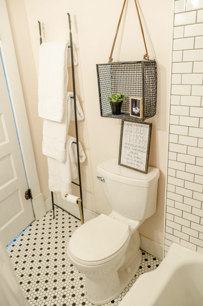 A weathered metal basket brings a touch of industrial chic to a modern bathroom while keeping essentials organized.