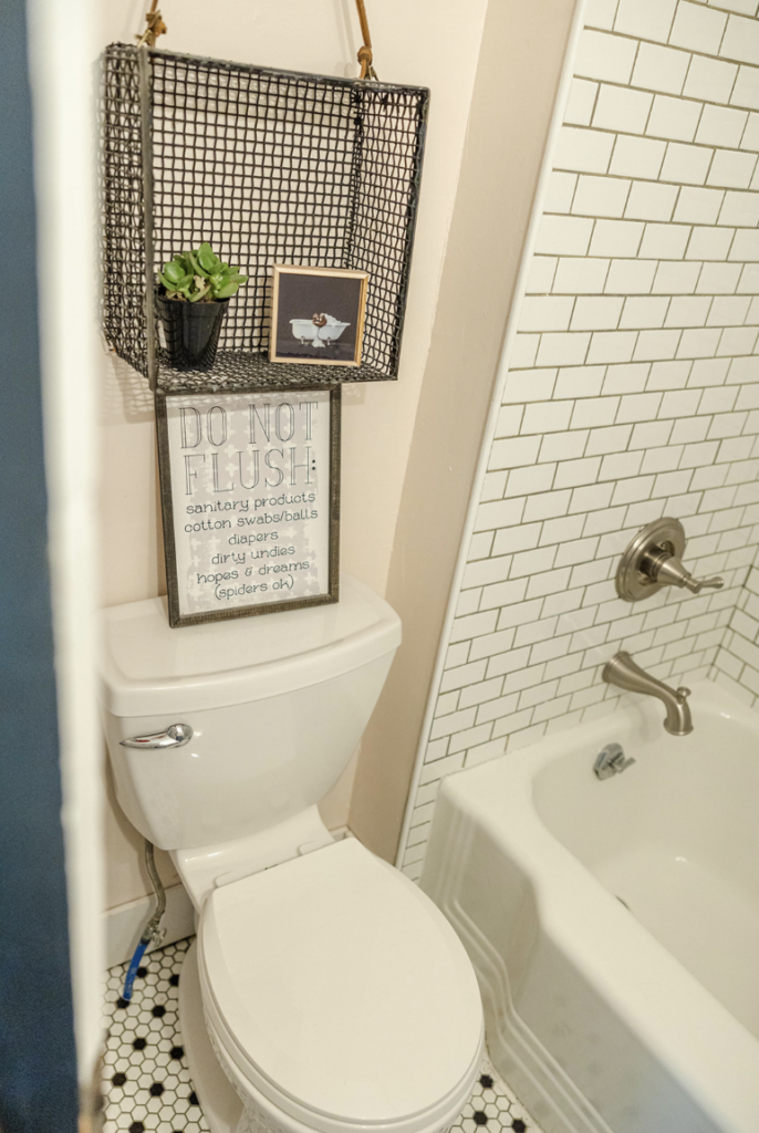 vintage metal basket, once a flea market find, now adds character to a bathroom as stylish storage