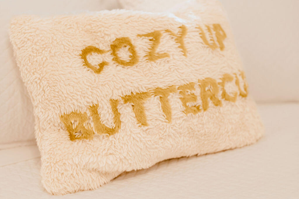 Cozy Up ButterCup Pillow in a cottagecore bedroom.