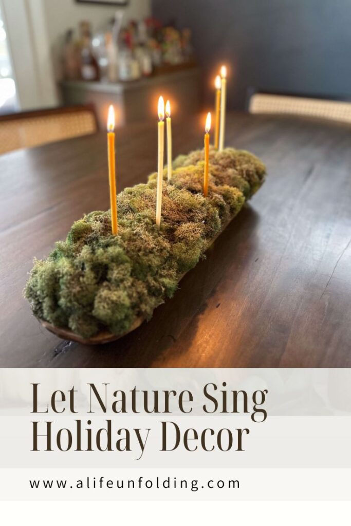 Moss filled dough bowl with skinny candles.