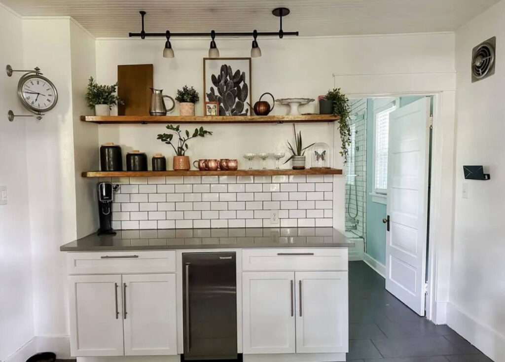 White Kitchen Cabinets with White Subway Tile, Grey quartz countertops and Natural Wood open shelves.