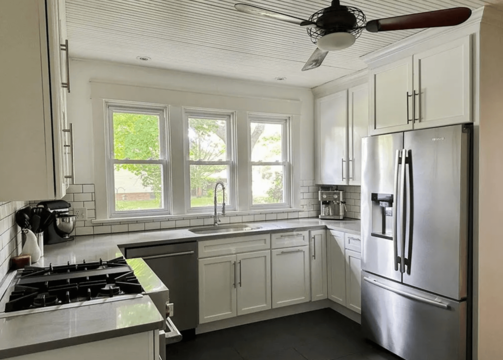 White Cabinets with Grey quartz countertops in a renovated vintage home.