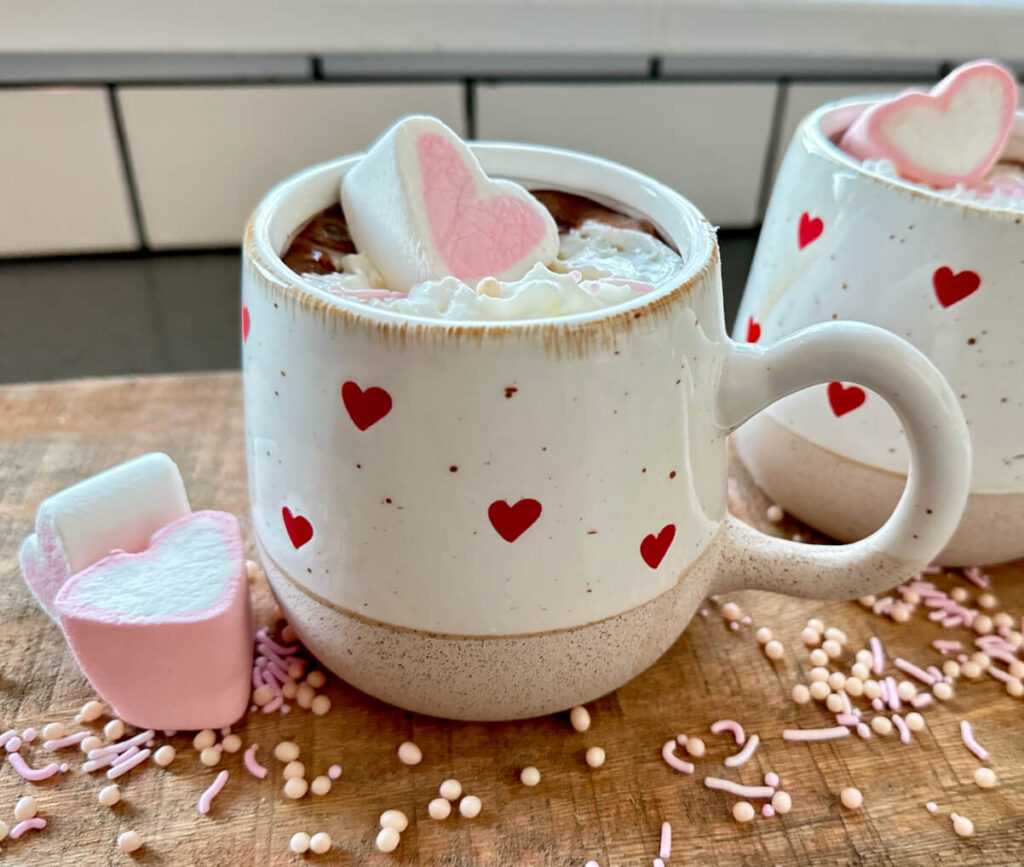 White Mug with Red Hearts filled with Spiked Hot Chocolate for Galentine's Day