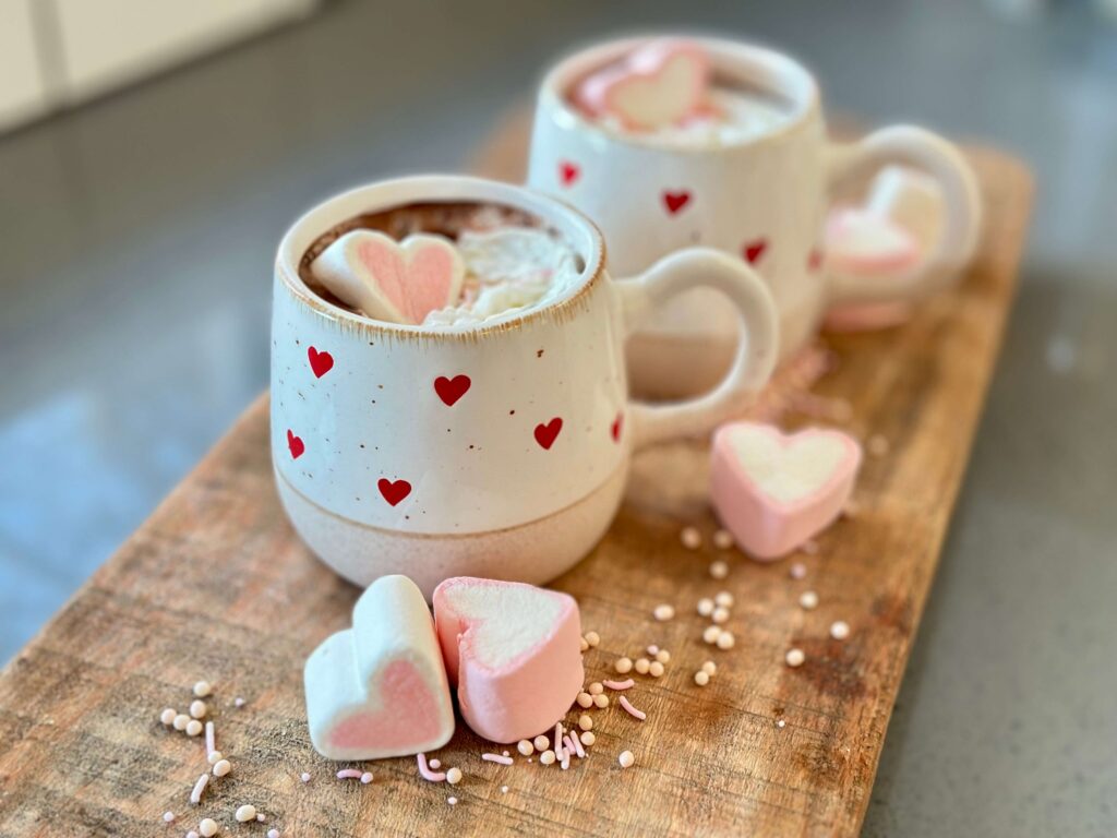 Mugs filled with Spiked Hot Chocolate for Galentine's Day.